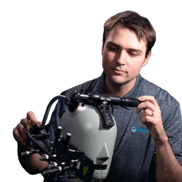 Element testing technician holding SAR head phantom for mobile phone radiation testing and certification