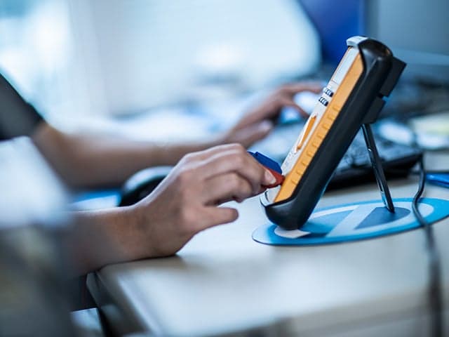 Element calibration services technician with precision measurement equipment for instrument testing