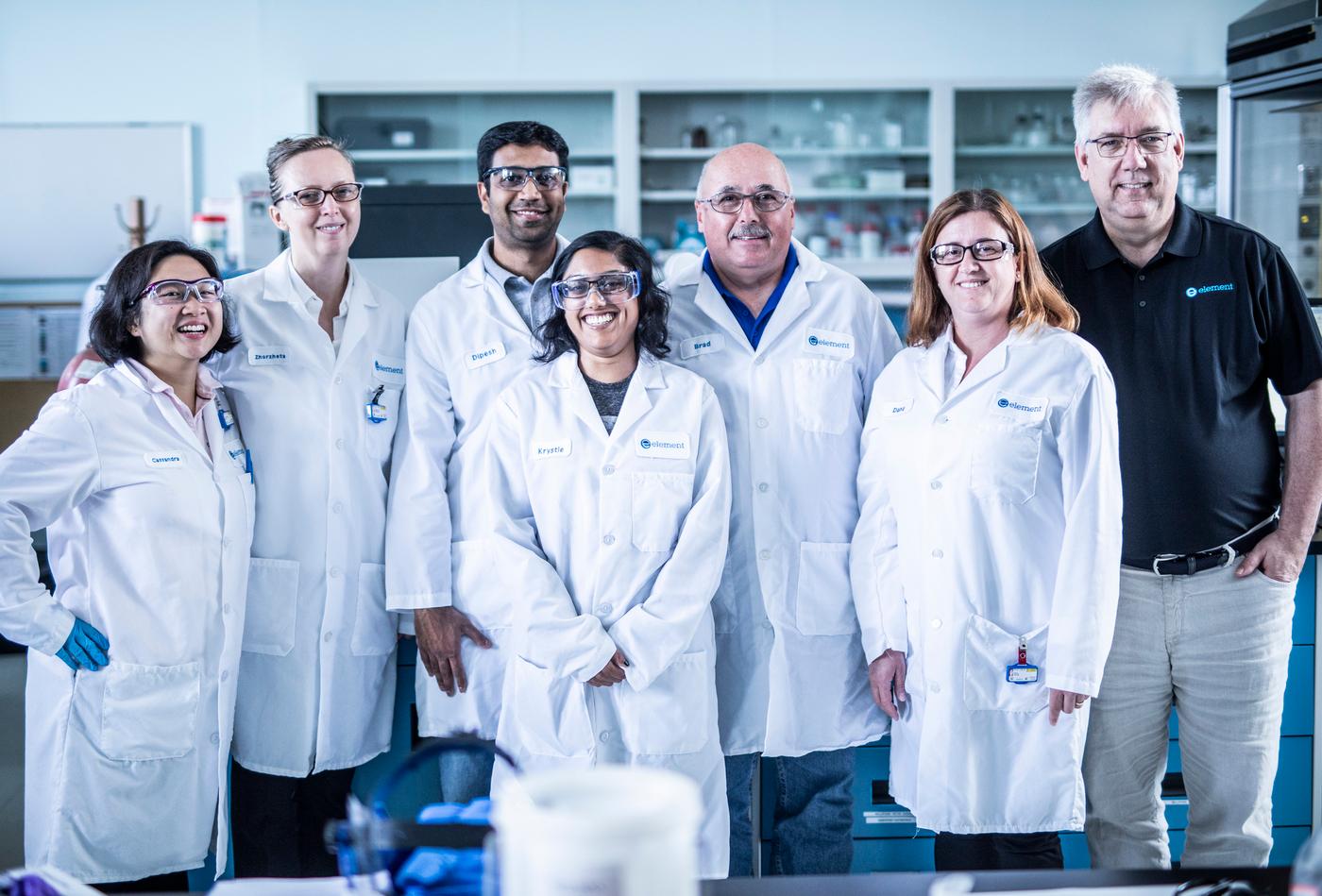 Diverse group of Element colleagues in a testing lab