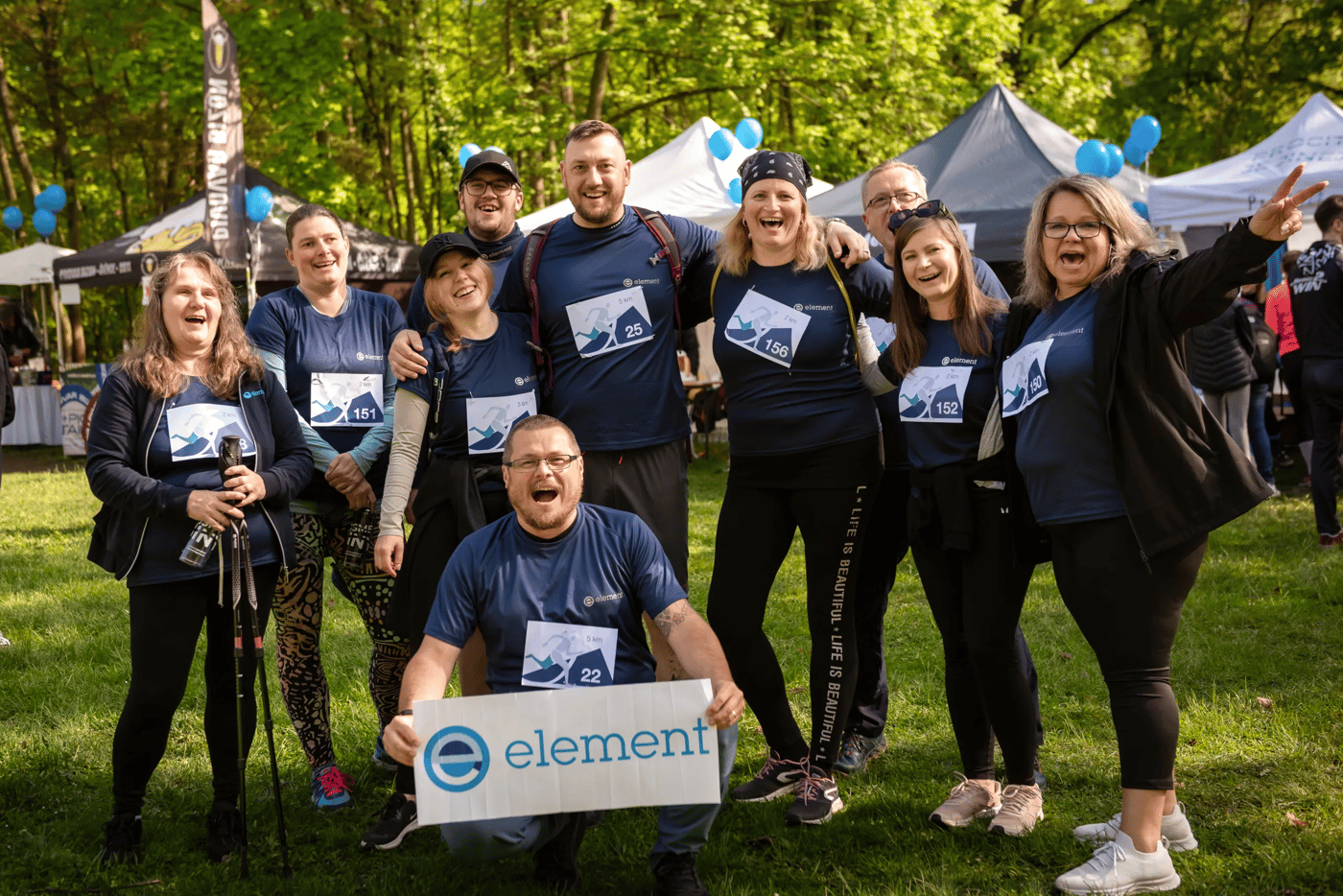 Group of Element colleagues wearing matching shirts gathered at an outdoor event