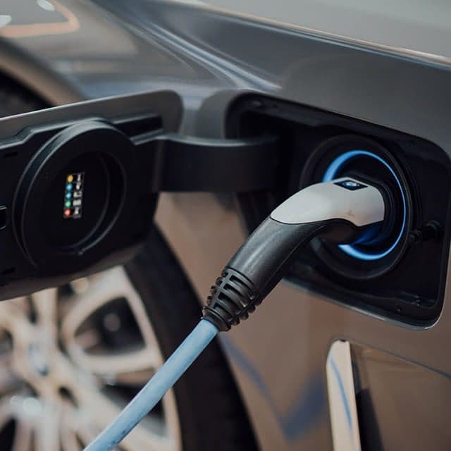 Electric vehicle charging port with cable plugged in