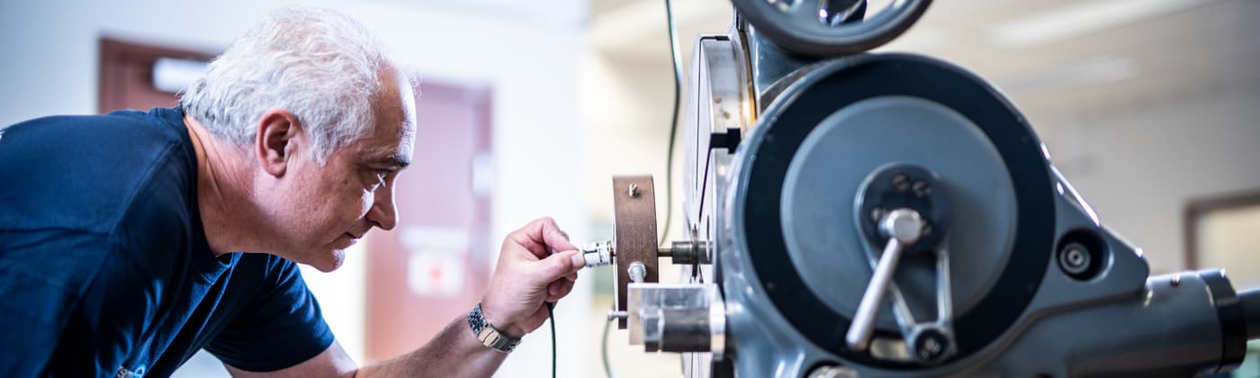 Element calibration services technician with precision measurement equipment for instrument testing