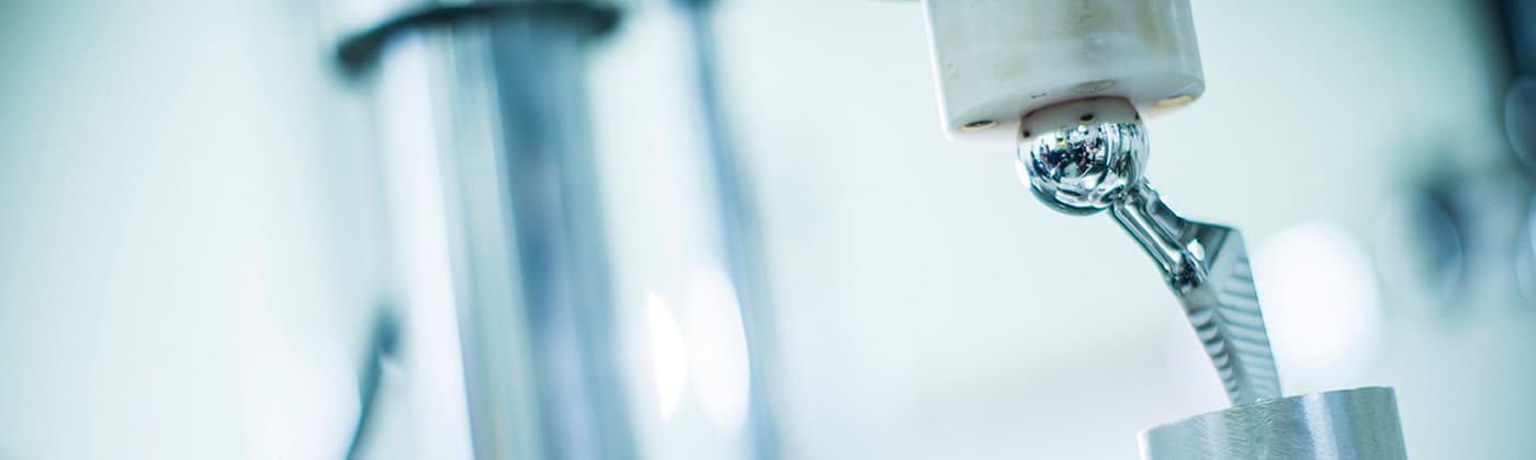 Two testing engineers standing together in Element medical device testing laboratory with specialized equipment around them