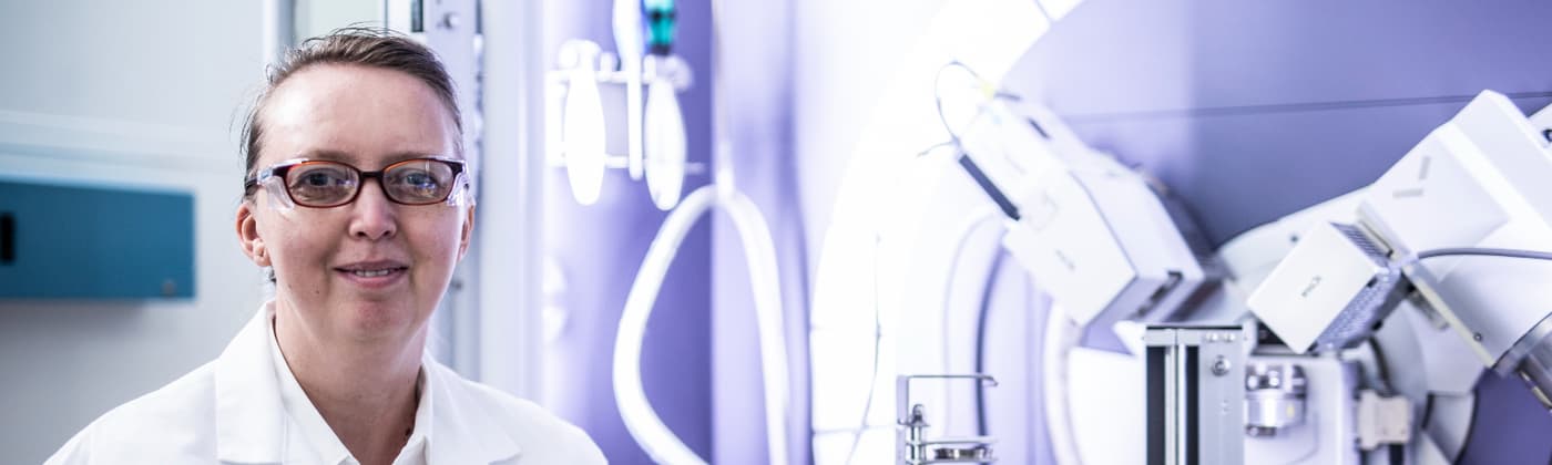 Element pharmaceutical testing scientist with laboratory equipment for drug development and compliance