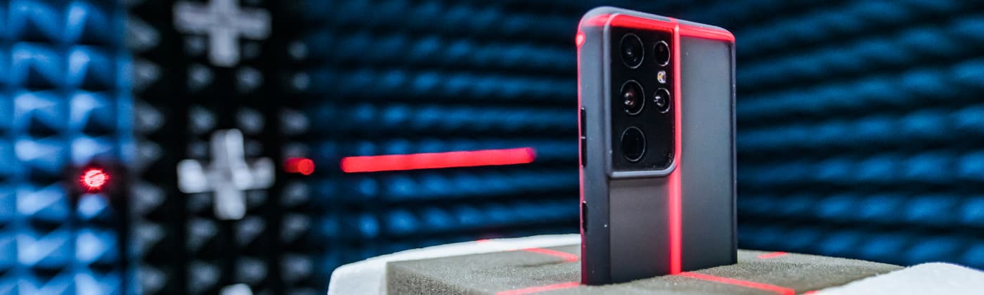 Smartphone undergoing OTA antenna testing in an anechoic chamber