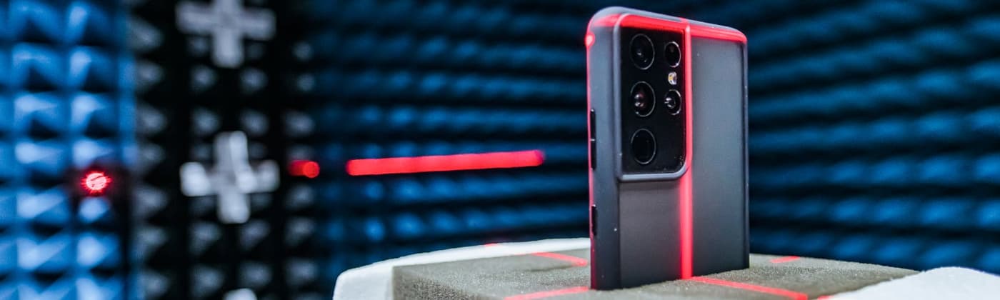 Smartphone undergoing OTA antenna testing in an anechoic chamber
