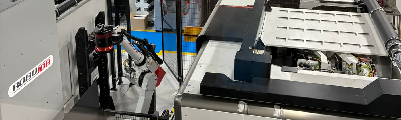 Robotic arm from a RoboJob automation system loading specimens into a machining cell at Element’s Lancaster laboratory