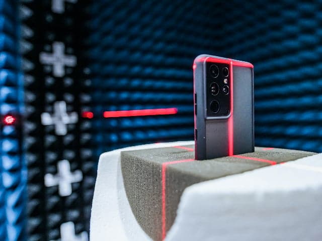 Smartphone undergoing OTA antenna testing in an anechoic chamber