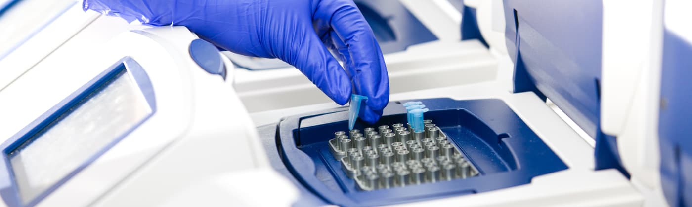 Analyst loading samples into PCR for rapid mycoplasma detection testing