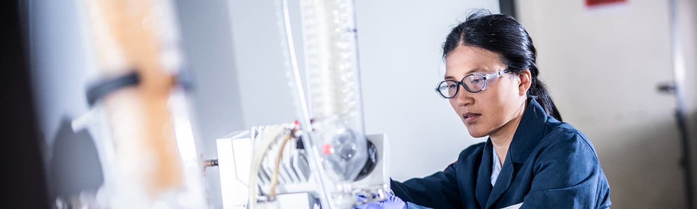 Element scientist operating laboratory equipment during chemical analysis