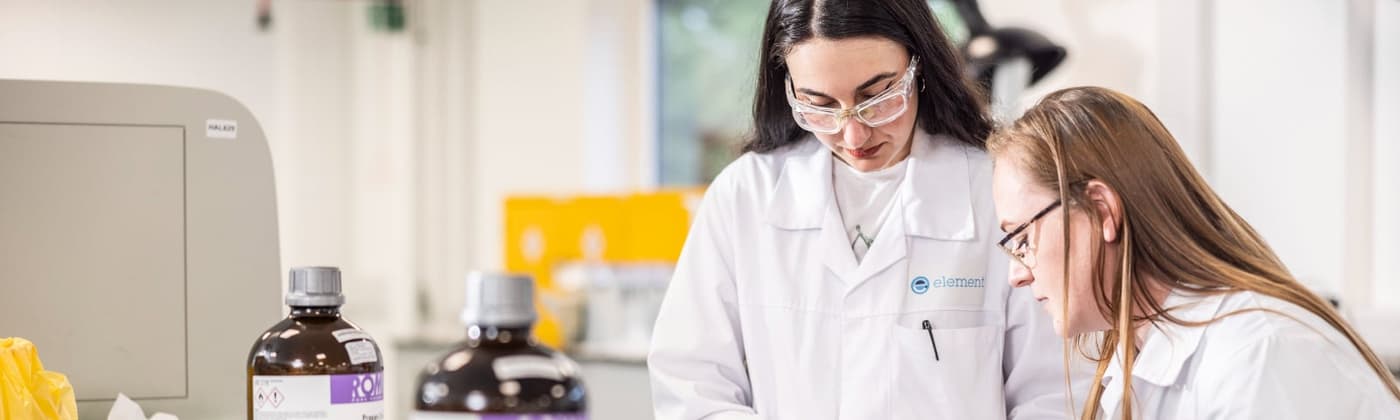 Two Element laboratory scientists collaborating on analytical method review in pharmaceutical testing facility