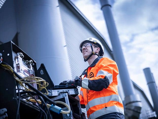 Stack engineer taking emissions sample on-site