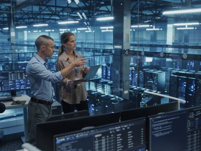 Close-up of a data center server rack with cables and indicator lights