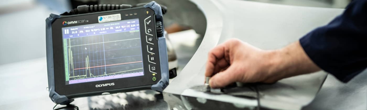man's hand performs ultrasonic testing