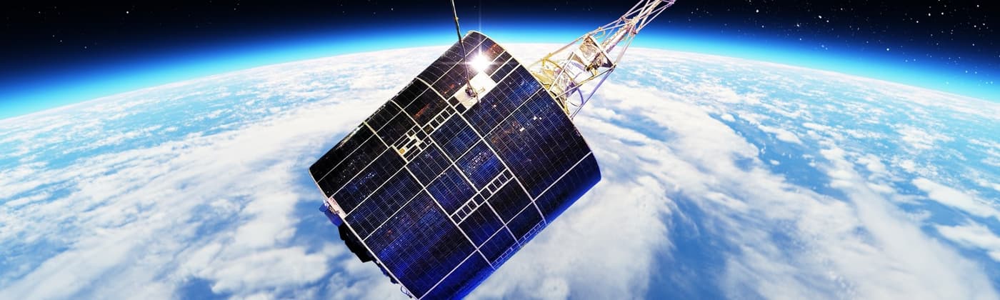 A satellite with solar panels orbiting Earth.