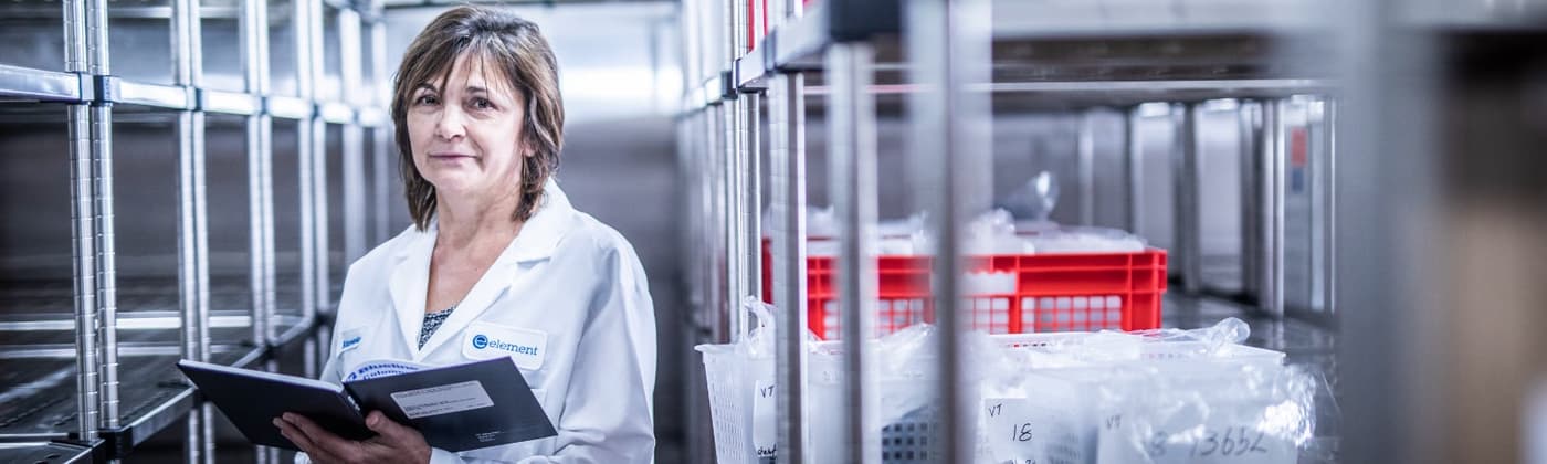 Scientist reviewing pharmaceutical stability samples on storage racks at Element Toronto laboratory