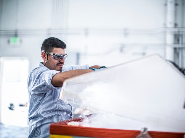 Test engineer opening a passivation tank for chemical processing.