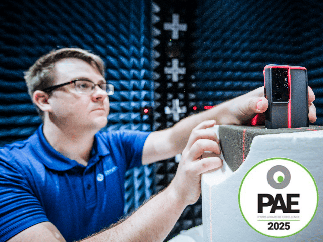Element expert holding cellular device with logo of PTCRB Awards of Excellence