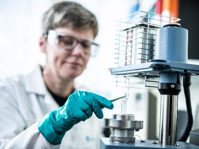 Thermal analysis expert inspecting a test sample.