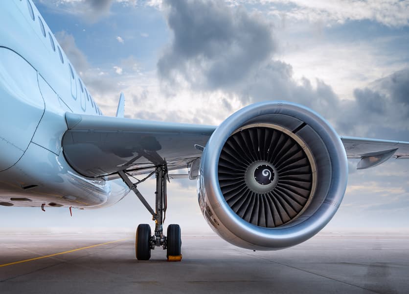 Close up of engine turbines of stationary airplane on a tarmac 
