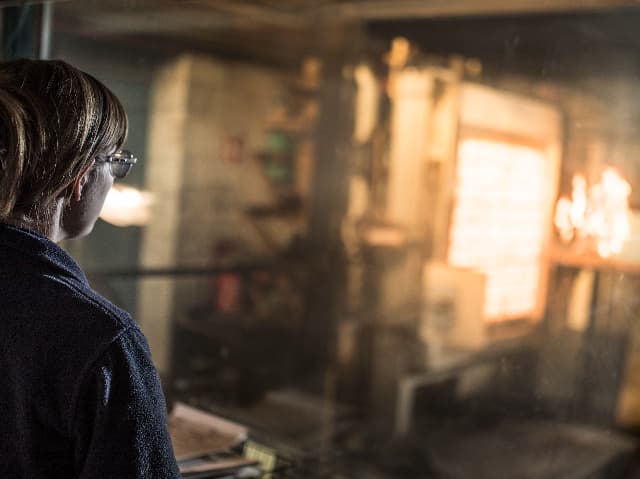 Fire testing engineer observing reaction to fire testing