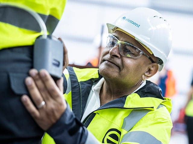 Technician conducting breathing air quality testing with monitoring device