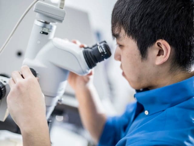 Testing equipment for coatings sitting on a green coating sample surface taking measurements