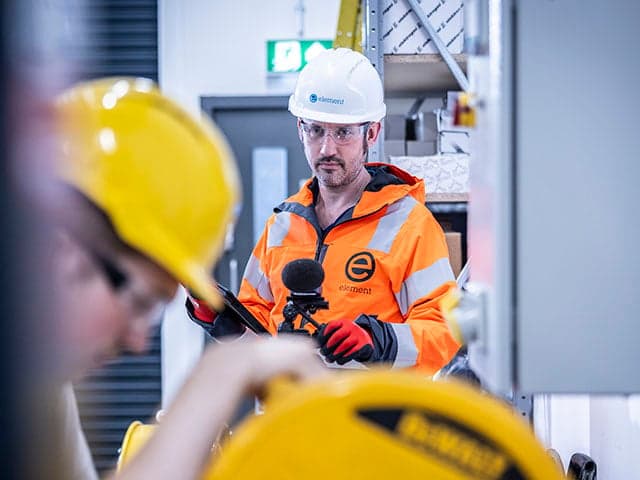 Occupational hygiene specialist conducting workplace safety assessment.