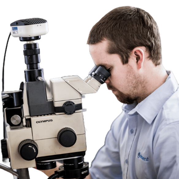 Materials testing scientist using microscope for quality analysis at Element laboratory