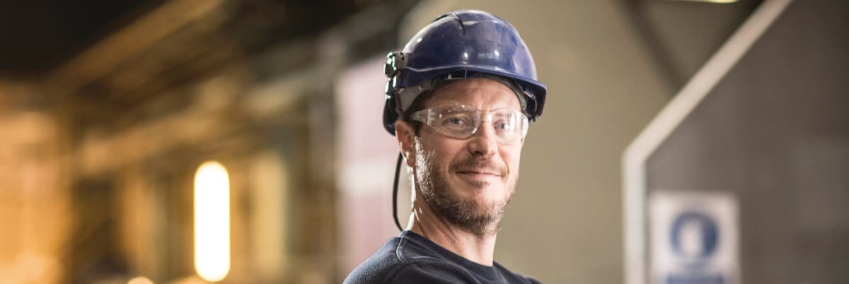 Element building products testing engineer wearing safety helmet and protective eyewear in industrial facility