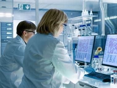 image of two scientists at compter terminals