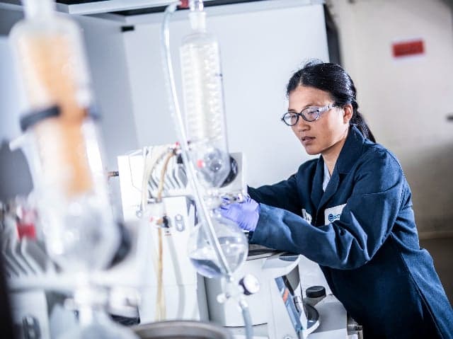 Element scientist operating laboratory equipment during chemical analysis