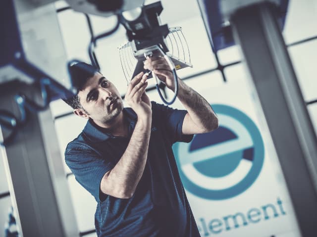 Engineer positioning a test antenna in an Element laboratory