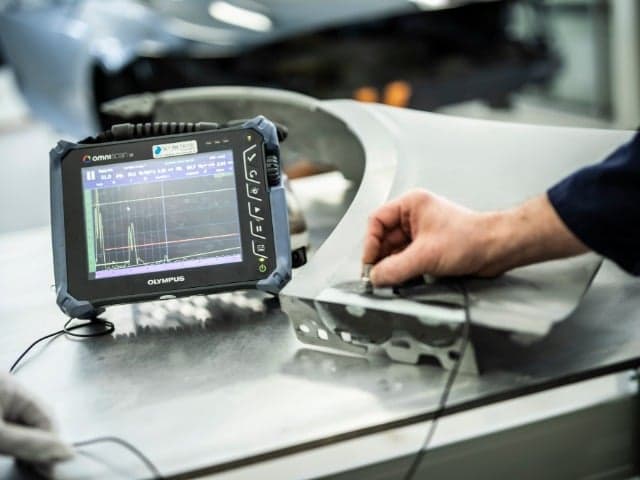 man's hand performs ultrasonic testing