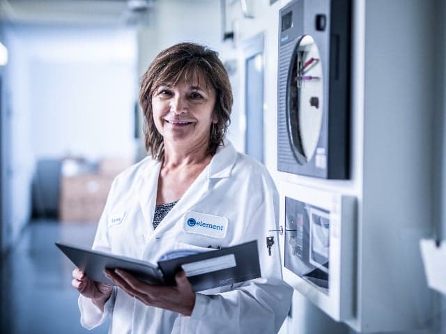 Pharmaceutical scientist standing by ICH-compliant stability storage chamber
